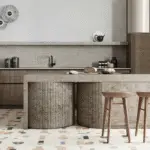 A Japandi kitchen design with a large stone kitchen island and wooden chairs.