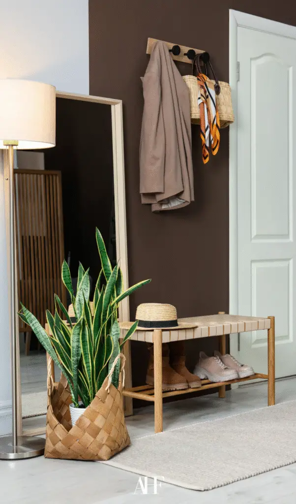 A hallway with a floor lamp and hooks on the walls with a jacket. Decorations. Interior design ideas.