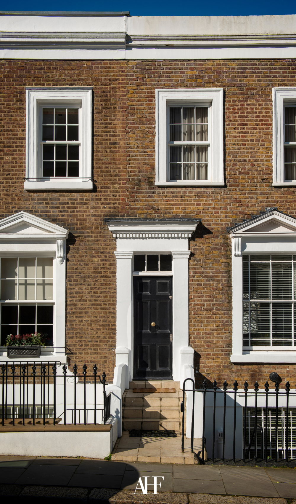 A London townhouse style front porch and entryway. Brick front. 