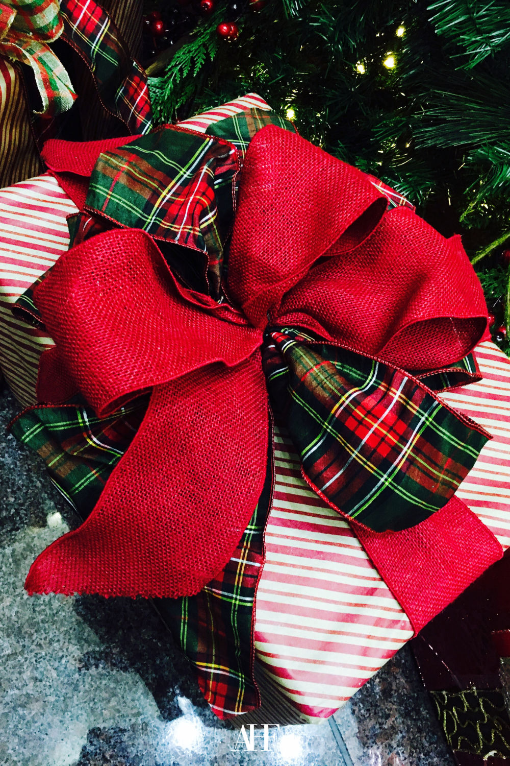 A Ralph Lauren Christmas Wrapping with red and tartan bow.